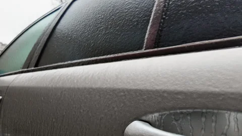Side view of a car window covered in frost and ice, creating a textured frozen 스톡 동영상 329402868