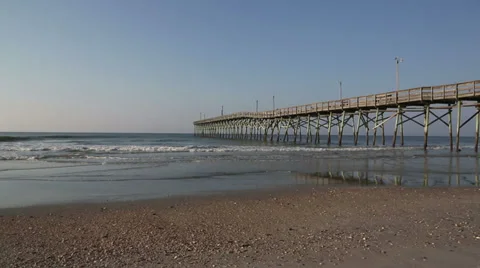Side view of Carolina beach pier in early morning Stock Footage