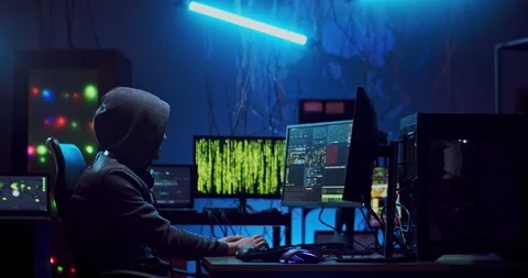 Side view on the Caucasian male software developer in hood working over hacking Stock Footage 124348078