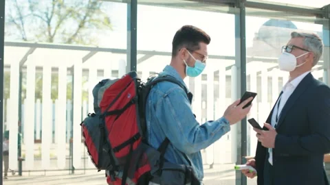 Side view of Caucasian man in mask travelling scanning qr code showing Stock Footage 154659985