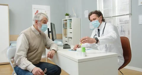 Side view of Caucasian man professional physician in medical mask in clinic room Stock Footage 145647469
