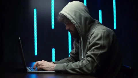 Side view of Caucasian programmer hacking online site or password sitting at Video stock 142510746