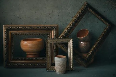 Side view ceramic cups  and bowls in picture frames like on painting Stock Photos