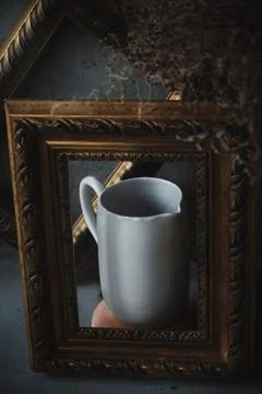 Side view ceramic white jar in picture frames like on painting Stock Photos