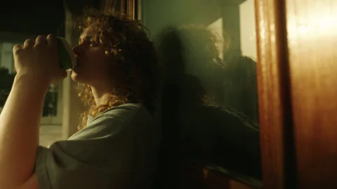 Side view of a charming curly haired woman drinking a cup of takeaway coffee Stock Footage 271305086