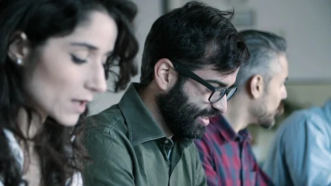 Side view of cheerful developer in eyeglasses working with laptop 動画素材 121402922