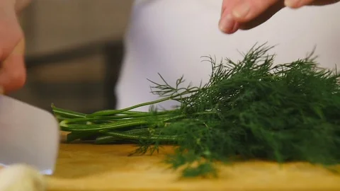 Side view chef cuts dill on a cutting board Stock Footage 76087516