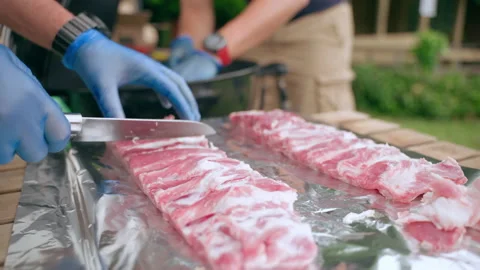 Side view of chef hands using sharp kitchen knife for cutting fat from fresh raw Stock-Footage 164394857