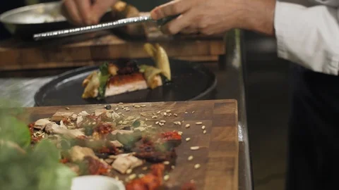 Side view. Chef hands in white uniform finish the serving of a traditional Stock Footage 88673563