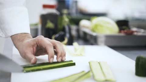 Side view of a chef slicing a cucumber 動画素材 90524373