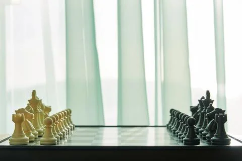 Side view of Chess board ready for the game on the room close to window Stock Photos
