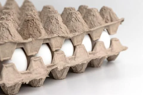 Side view on chicken raw eggs in carton recyclable cardboard box. Close-up vi 库存照片