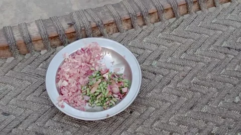 Side View of Chopped Onion and Green Vegetables on a Plate Stock-Footage 346869317