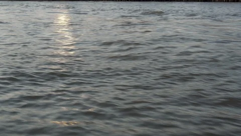 Side view of city river surface from ferry boat and sunlight reflections Stock Footage 120929869