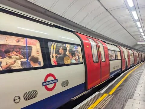 Side view of a classic London Underground train arriving at Tottenham Court Road Stock Photos