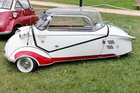 Side view of a classic three-wheel Messerschmitt KR 200 with red elements near t 스톡 사진