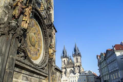 Side view of clock tower in Prague with historical buildings Stock Photos