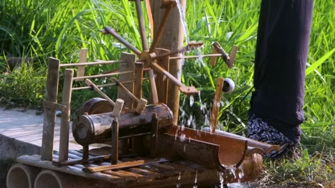 Side View Close Up of Bamboo Water Wheel Craft Operating in Irrigation Channe Stock Footage 344661198