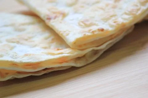 Side view close up of crispy stacked homemade flatbread resting on a smooth.. Fotos Stock