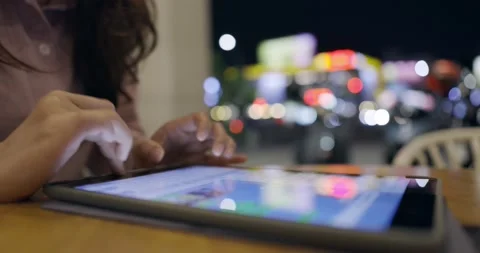 Side view, close up of a female hand using digital tablet .Lifestyle and tech Stock Footage 233596164