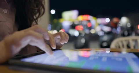 Side view, close up of a female hand using digital tablet .Lifestyle and tech Stock Footage 233596182