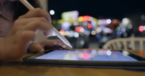 Side view, close up of a female hand using digital tablet with a pen while wo Stock Footage 233596214
