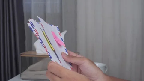 Side view close up of hands sorting envelopes on table Stock Footage 277177286