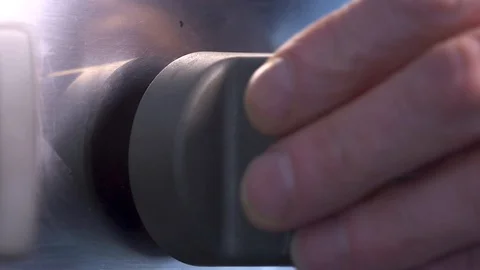 Side view close up of the knob being turned to ignite a gas ring on a Stock Footage 125470619