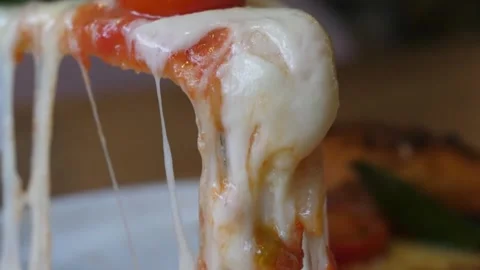 Side View Close-up of Lifting a Hot Margherita Pizza Slice with Stretchy Melted Stock Footage 337678541