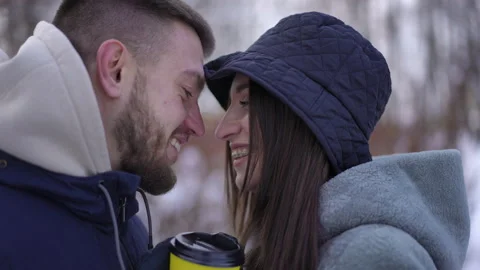 Side view close-up loving couple rubbing noses kissing smiling standing outdoors Stock Footage 219904962