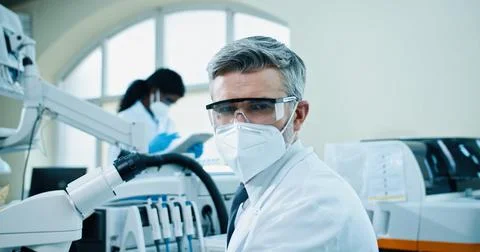 Side view. Close up of middle-aged Caucasian man medical scientist working in Stock Photos