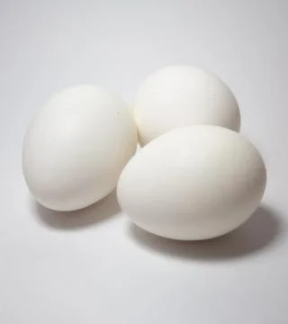 Side view, close up picture of three eggs , isolated ,on white background Stock Photos