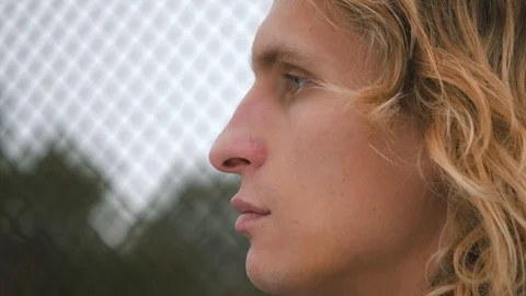 Side view of close up portrait. Stylish hipster man face with long blond hair pu Stock Footage 119870098
