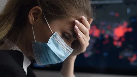 Side view close-up portrait of a young woman in disposable medical facial mask Stock Footage 129557527