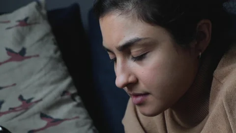 Side View Close Up Of A Serious Young Indian Woman Lying On A Bed Stock Footage 134945435