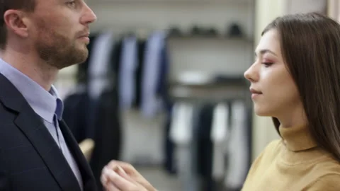A side view close up shot of a clothing shop consultant making final adjustments Stock Footage 131471579