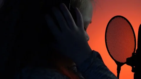 Side view close-up shot of cute little girl getting ready to sing with a Stock Footage 75200036