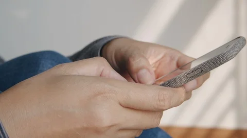 Side view. Close up shot Hand of young women using smart phone while sitting Stock Footage 121897779