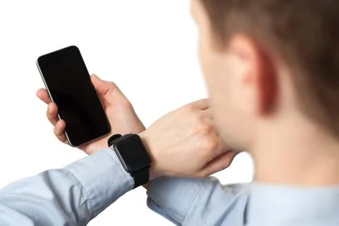 Side view, close-up of a smartphone with a blank screen and a smart watch on  Stock Photos
