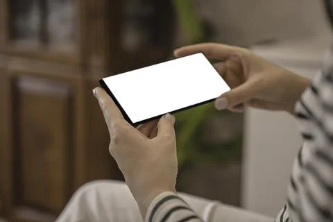 Side view of close-up woman's hands holding smartphone. Stock Photos