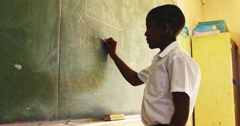 Side view close up of a young African schoolboy standing at the front of th.. Stock Photos