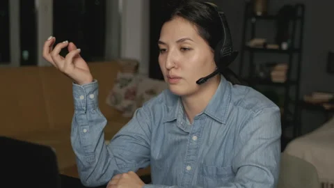 Side view Close-Up of a Young Asian Woman in Headphones with a Microphone Stock Footage 144434689