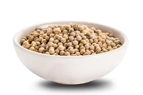 Side view closeup of white pepper in ceramic cup on white background. Stock Photos