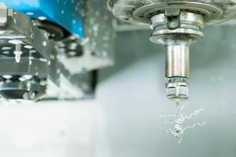 Side view on CNC milling machine drill with metal shaving scrap on it Stock Photos