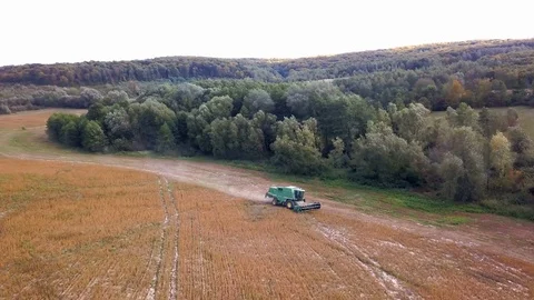 Side view of combine machine working on a field Stock Footage 122867228