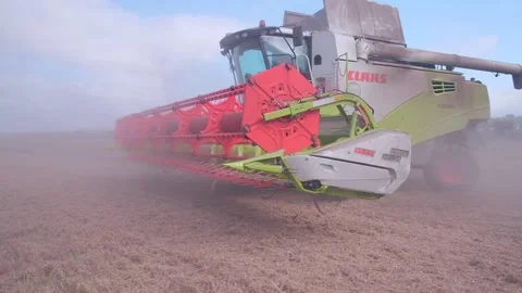 Side view Combines in a wheat field. Combine agricultural machine Stock Footage 160394081