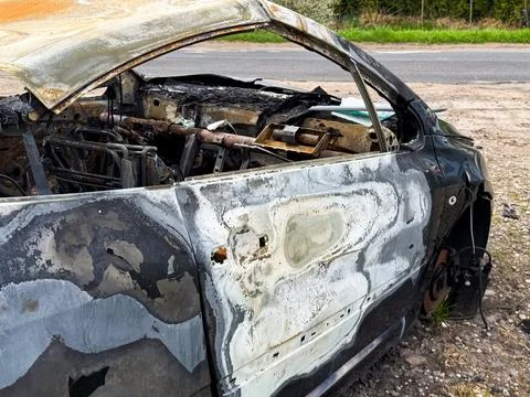Side view of a completely burned car showing warped and blistered paint, mi.. Stock Photos