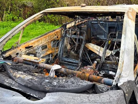 Side view of a completely destroyed car cabin with burnt seats, exposed met.. Stock Photos