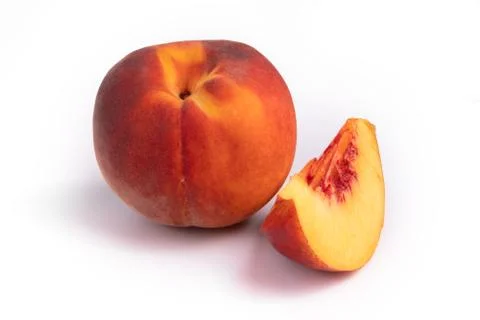 Side view on a composition of one whole peach and a slice of it Stock Photos