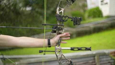 A side view of a compound bow being drawn and fired with a very shallow Video stock 139261119